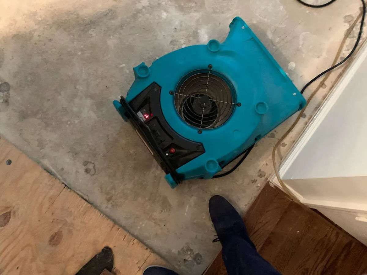 Air mover drying subfloor during Commercial Water Damage Restoration in Connerton
